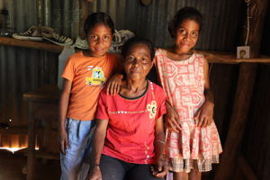 Juliana with her mum and sister at home